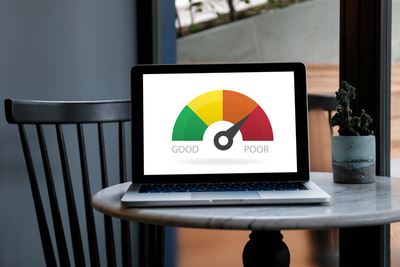A laptop showing a fico score meter